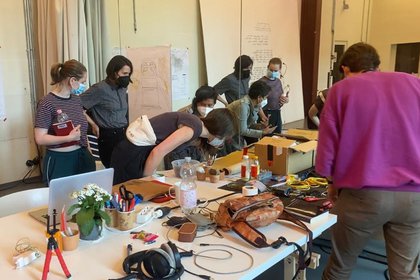 People looking at different things on a table 