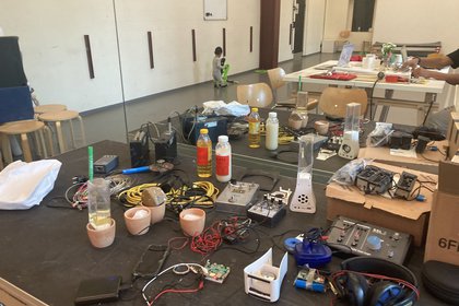 Table full of different utensils and tech stuff