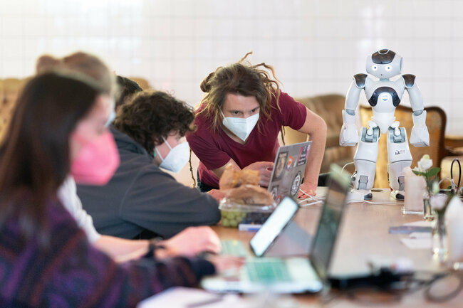 Eine Gruppe von Studierenden lernt einen Roboter zu programmieren